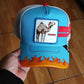 Gorra trucker azul y blanca dromedario Smokin' Somebody Stop Me Supercharged The Farm de Goorin Bros.